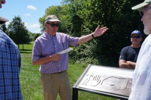 Retired President/CEO Mark Michel recounts the saga of The Hopewell site’s preservation in front on an NPS interpretive sign at the site. Photo Bliss Bruen/The Archaeological Conservancy.