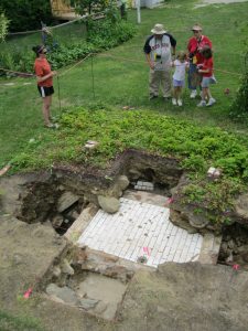 Strawbery Banke guide Christina Errico offers public interpretation of the mikveh to visitors.<br />Photo Credit: Strawbery Banke Museum