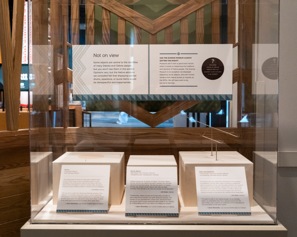 Photo of museum display case with signs explaining that items have been reomoved from display.